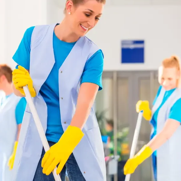Cleaning team disinfecting hospital floor as part of medical institution cleaning services